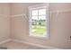 Large walk-in closet with window, carpet, and wire shelving at 65 Oakhurst Trl, Sharpsburg, GA 30277