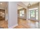Bright and spacious entryway with hardwood floors and views to the kitchen at 65 Oakhurst Trl, Sharpsburg, GA 30277