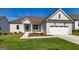 Craftsman style home with a two-car garage and nicely landscaped lawn at 65 Oakhurst Trl, Sharpsburg, GA 30277