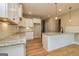 Modern kitchen with white shaker cabinets, granite countertops and island at 65 Oakhurst Trl, Sharpsburg, GA 30277