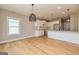 Open concept kitchen with white cabinets, granite countertops, and light hardwood floors at 65 Oakhurst Trl, Sharpsburg, GA 30277