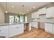 Modern kitchen with white shaker cabinets, granite countertops and island at 65 Oakhurst Trl, Sharpsburg, GA 30277