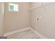 Laundry room with tile floor, shelving, and space for a washer and dryer at 65 Oakhurst Trl, Sharpsburg, GA 30277