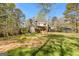 House with a large backyard, deck, and wooded area at 8078 Longleaf Dr, Villa Rica, GA 30180