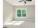 Well-lit bedroom with large window, ceiling fan, and neutral walls at 20 Platinum Rdg, Sharpsburg, GA 30277