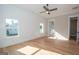 Spacious bedroom with wood floors, ceiling fan, and en-suite bathroom at 20 Platinum Rdg, Sharpsburg, GA 30277