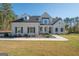 Two story house with a light beige exterior, dark shutters, and a nicely landscaped lawn at 20 Platinum Rdg, Sharpsburg, GA 30277