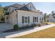 A side view of the house showing a three car garage and a walkway at 20 Platinum Rdg, Sharpsburg, GA 30277