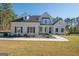 Two story house with a light beige exterior, dark shutters, and a nicely landscaped lawn at 20 Platinum Rdg, Sharpsburg, GA 30277