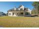 Back of house showcasing covered patio and landscaping at 20 Platinum Rdg, Sharpsburg, GA 30277