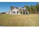 White two-story house with covered patio and grassy yard at 20 Platinum Rdg, Sharpsburg, GA 30277