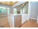 Modern kitchen island with farmhouse sink and stainless steel dishwasher at 20 Platinum Rdg, Sharpsburg, GA 30277