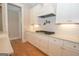 Modern kitchen with white cabinets, gas cooktop and a pot filler at 20 Platinum Rdg, Sharpsburg, GA 30277