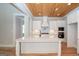 Kitchen with white cabinets, quartz counters and island at 20 Platinum Rdg, Sharpsburg, GA 30277