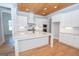 Kitchen with white cabinets, quartz counters and island at 20 Platinum Rdg, Sharpsburg, GA 30277
