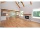 Open living room featuring hardwood floors, a stone fireplace, and kitchen views at 20 Platinum Rdg, Sharpsburg, GA 30277