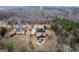 An aerial shot showcases a home with a pool and large backyard surrounded by many trees at 25 Abelia Dr, Covington, GA 30014