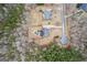 Aerial view of backyard pool with a diving board and a house surrounded by trees at 25 Abelia Dr, Covington, GA 30014
