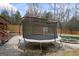 Backyard view with a trampoline beside the pool, offering outdoor fun at 25 Abelia Dr, Covington, GA 30014