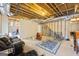 An unfinished basement that has a leather sofa and exposed beams at 25 Abelia Dr, Covington, GA 30014