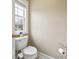 Modest half bath featuring standard toilet, tan walls and ceramic tile floor at 25 Abelia Dr, Covington, GA 30014