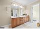 Bright bathroom featuring double sink vanity, ceramic tile floor and full mirror at 25 Abelia Dr, Covington, GA 30014