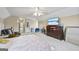 Bright bedroom with large bed, carpeted floor, ceiling fan and dresser at 25 Abelia Dr, Covington, GA 30014