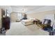 Spacious bedroom with beige walls, carpeted floors, ceiling fan, and large TV at 25 Abelia Dr, Covington, GA 30014