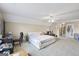 Large bedroom features neutral carpet, a large bed, and natural light at 25 Abelia Dr, Covington, GA 30014