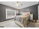 Gray bedroom with a ceiling fan and natural light from a large window at 25 Abelia Dr, Covington, GA 30014