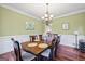 Formal dining room featuring a large table, chandelier, and ample seating at 25 Abelia Dr, Covington, GA 30014