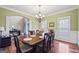 Traditional dining room with a decorative chandelier and seating for six at 25 Abelia Dr, Covington, GA 30014