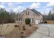 Brick house with two-car garage and inviting front porch, surrounded by trees at 25 Abelia Dr, Covington, GA 30014