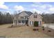 Charming two-story brick home featuring a cozy front porch and well-manicured lawn at 25 Abelia Dr, Covington, GA 30014