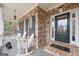 Relaxing front porch with rocking chairs and a stylish front door at 25 Abelia Dr, Covington, GA 30014