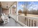 Cozy front porch with white railings and ample space for outdoor seating at 25 Abelia Dr, Covington, GA 30014