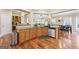 Open kitchen with tile countertops, stainless steel dishwasher, wood cabinets, and hardwood floors at 25 Abelia Dr, Covington, GA 30014