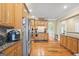 Bright kitchen featuring stainless appliances, granite countertops, and wooden cabinets at 25 Abelia Dr, Covington, GA 30014