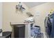 Functional laundry room with shelving, folding table, washer, dryer and tile floor at 25 Abelia Dr, Covington, GA 30014