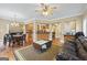 Spacious living room with hardwood floors open to dining and kitchen at 25 Abelia Dr, Covington, GA 30014