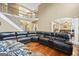 Open-concept living room features a large sectional sofa and view of the second story at 25 Abelia Dr, Covington, GA 30014