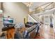 Open-concept living room with high ceilings, a staircase, and a large sectional sofa at 25 Abelia Dr, Covington, GA 30014