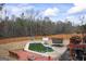 Backyard with a pool, wood deck, trampoline, basketball hoop, and slide at 25 Abelia Dr, Covington, GA 30014