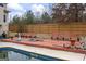 Fenced backyard with a private pool and wooden deck is perfect for outdoor gatherings at 25 Abelia Dr, Covington, GA 30014