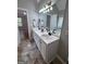 Well-appointed bathroom with double sinks, white cabinets, and a large mirror reflecting natural light at 110 Cloverwood Dr, Fayetteville, GA 30215