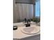 Bright bathroom mirror reflects a patterned shower curtain, decorative plant and updated fixtures at 110 Cloverwood Dr, Fayetteville, GA 30215
