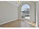 This bedroom is a blank canvas with ample light from a large, arched window and gleaming wood floors at 110 Cloverwood Dr, Fayetteville, GA 30215