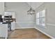 Bright dining area showcasing a stylish light fixture and large windows that fill the space with natural light at 110 Cloverwood Dr, Fayetteville, GA 30215