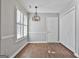Inviting dining area with modern light fixture, white door, and window, creating an ideal space for meals at 110 Cloverwood Dr, Fayetteville, GA 30215