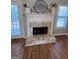 Elegant fireplace featuring stone surround, white mantle, and decorative accents, creating a cozy and inviting ambiance at 110 Cloverwood Dr, Fayetteville, GA 30215